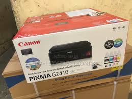 Canon PIXMA G2410 All-in-one MegaTank printer showing integrated ink tanks and GI-490 ink bottles.